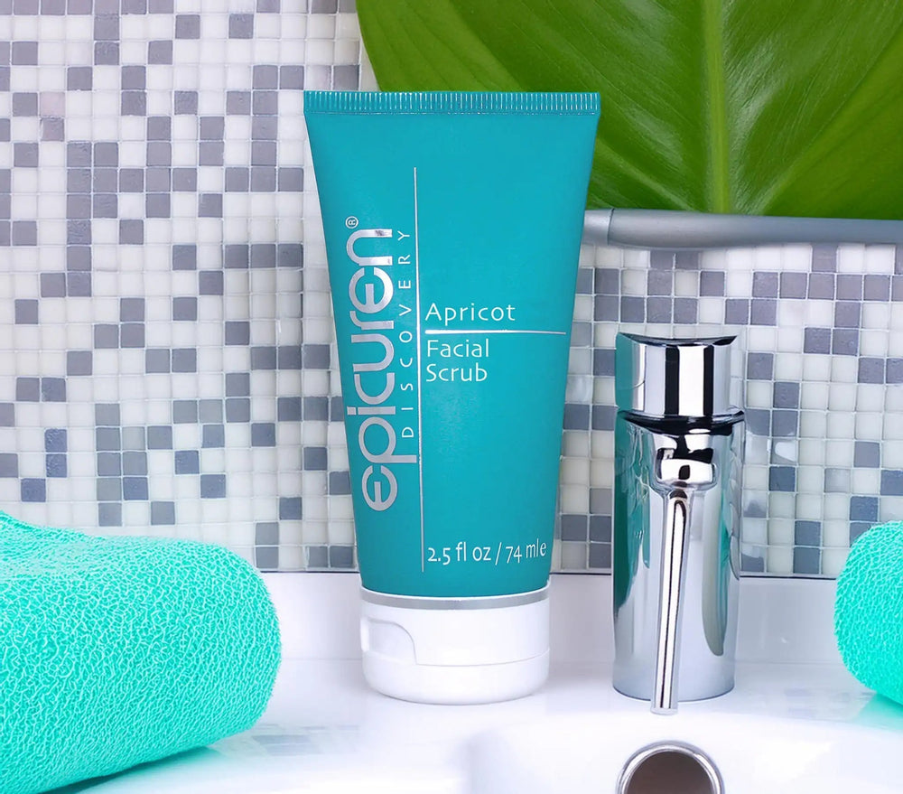 Tube of epicuren Apricot Facial Scrub with sponges on a light blue tiled background
